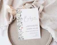 Editable lavender baby shower invitation with floral design and soft colors.